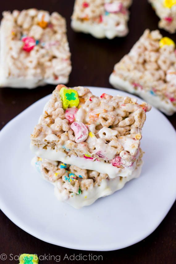 Lucky Charms Rice Krispie Treats loaded with marshmallows and white chocolate. Recipe by sallysbakingaddiction.com