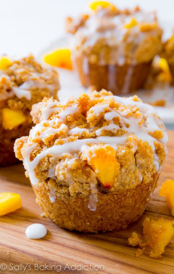 One seriously sweet muffin! These buttery peach muffins are loaded with flavor, crumb topping, and sweet glaze.