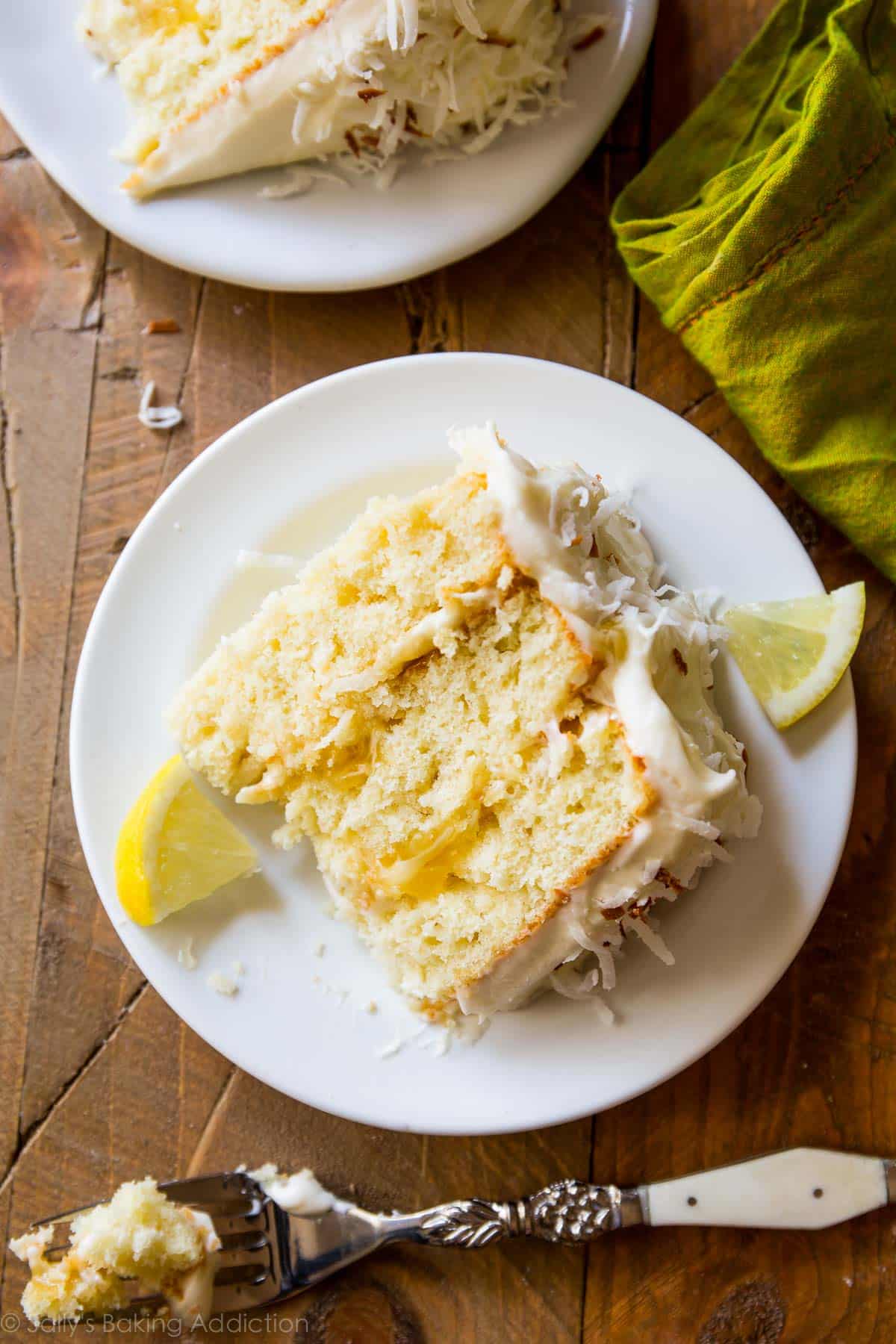 Lemon coconut cake, with deliciously moist coconut cake layers, homemade lemon curd, toasted coconut and cream cheese frosting, is a family favorite! sallysbakingaddiction.com