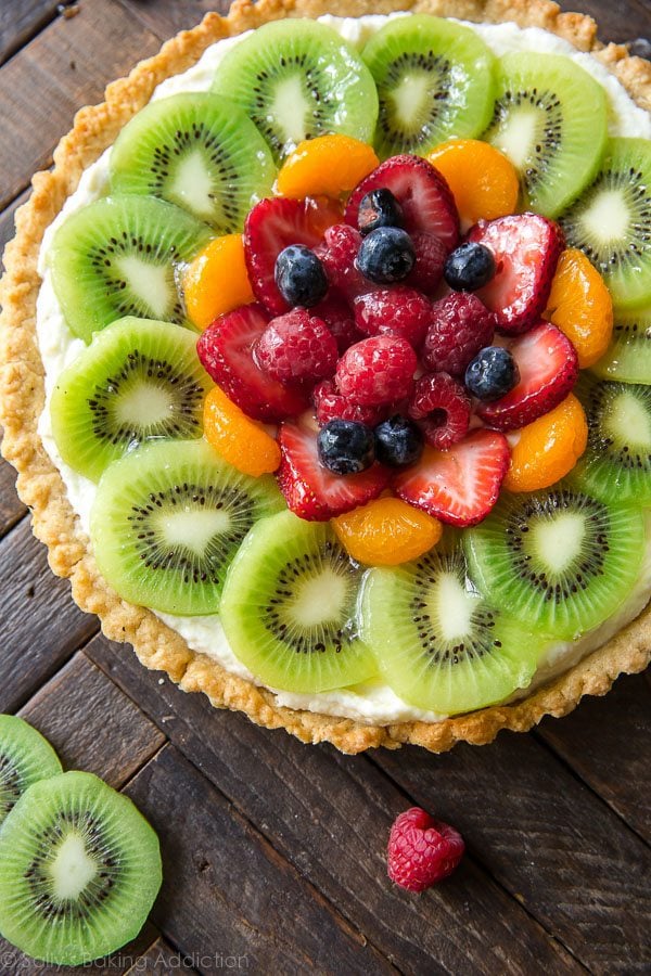 How to make homemade fresh fruit tart with buttery pastry crust and mascarpone cream filling! Recipe and step pictures on sallysbakingaddiction.com