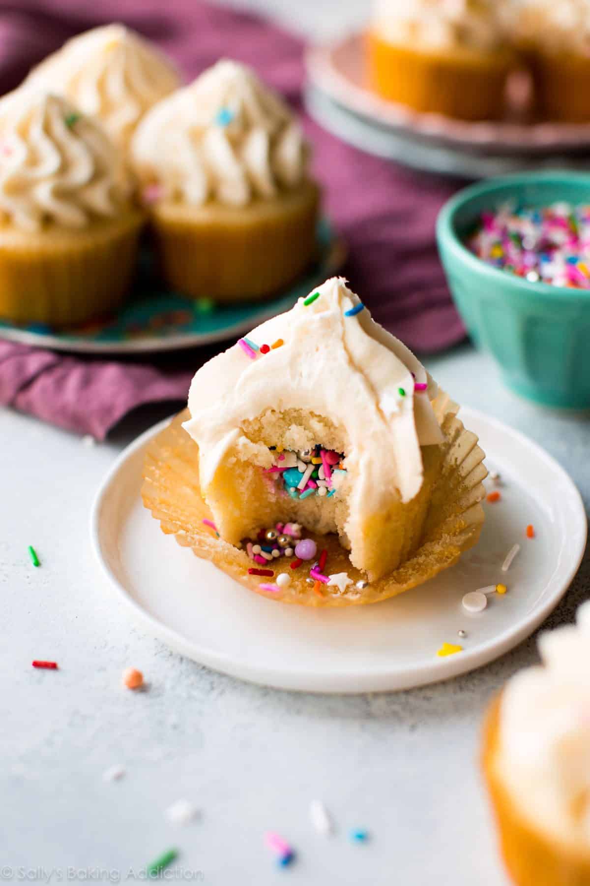 How to make party piñata cupcakes filled with sprinkles! Easy to make and ready for any celebration. Recipe on sallysbakingaddiction.com
