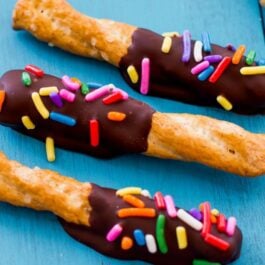 pretzels dipped in chocolate and topped with sprinkles