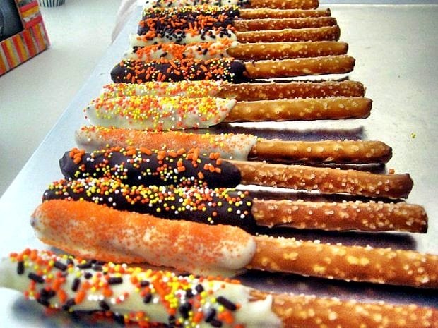 chocolate covered pretzel rods with fall sprinkles