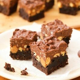 peanut butter cup crunch brownies on a cream plate