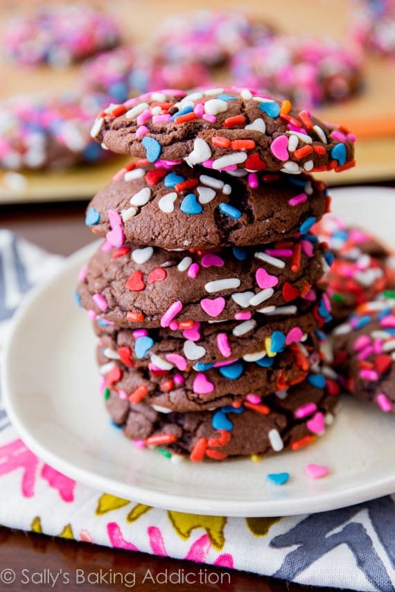 stack of chocolate cake mix cookies with sprinkles on a white plate