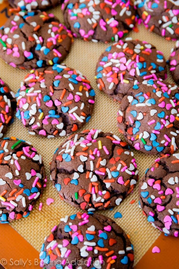 chocolate cake mix cookies with sprinkles on a silpat baking mat