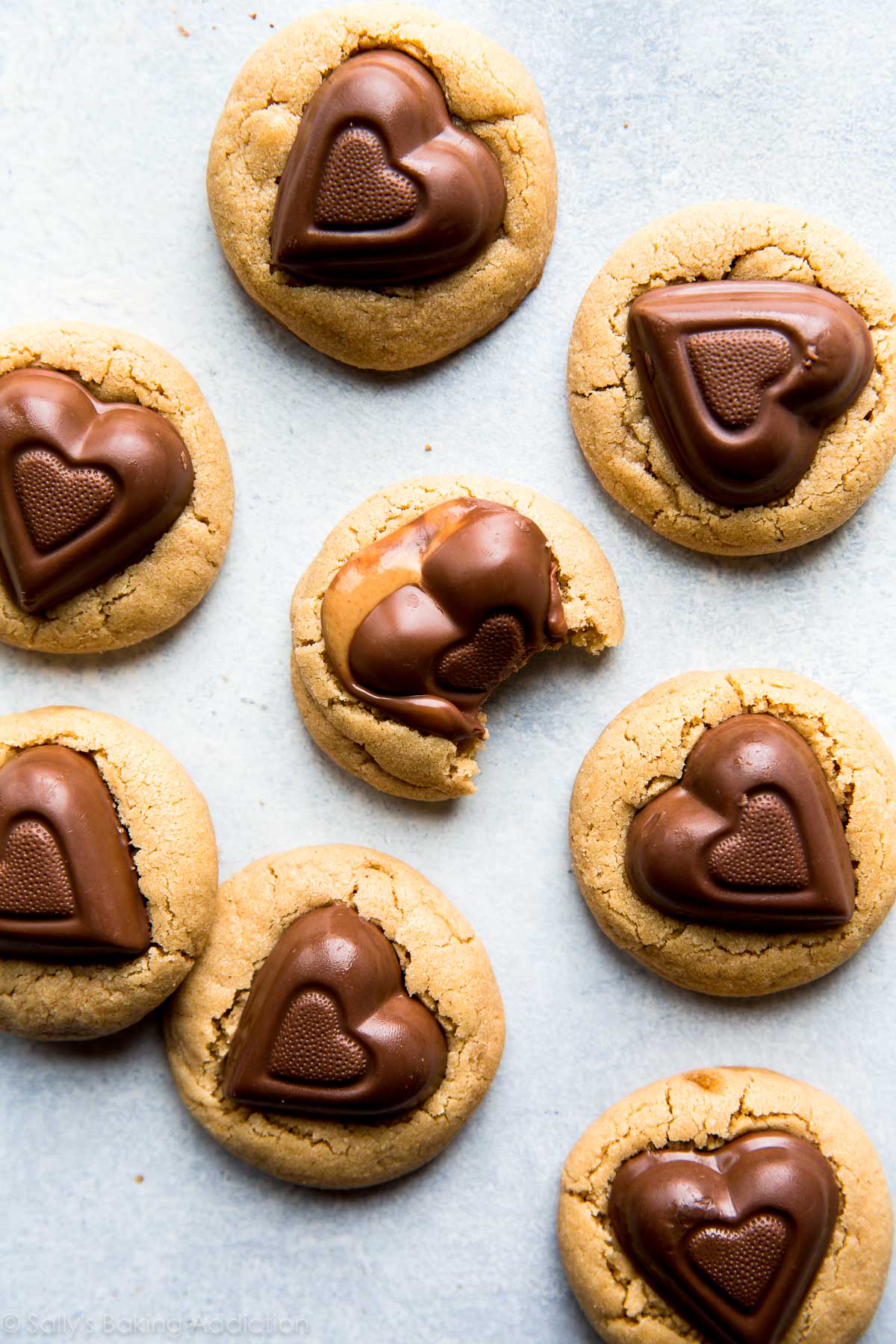 peanut butter cookies with chocolate heart candies on top