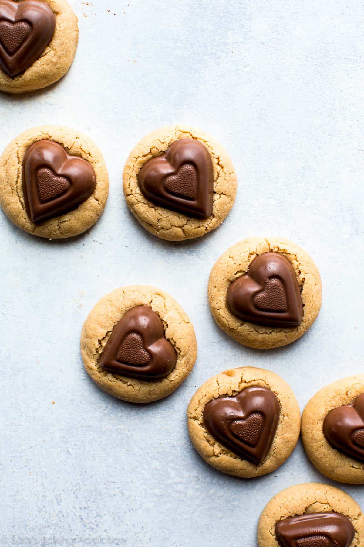 peanut butter cookies with chocolate heart candies on top