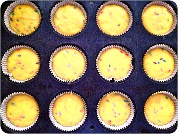 yellow cupcake batter in cupcake pan