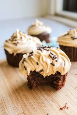 brownie cupcakes with peanut butter frosting with 1 bite taken out