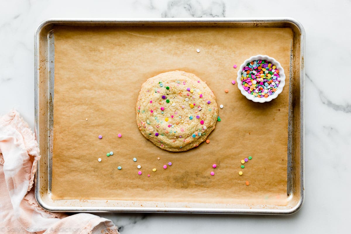 one large sugar cookie on lined baking sheet