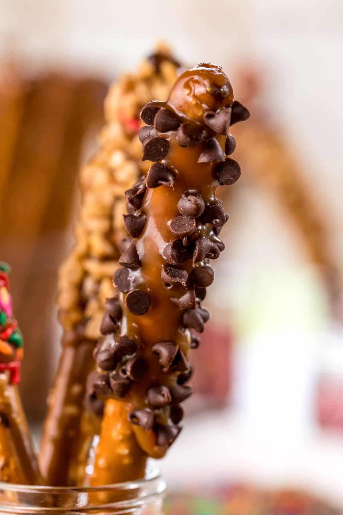 pretzel rods dipped in caramel with various toppings