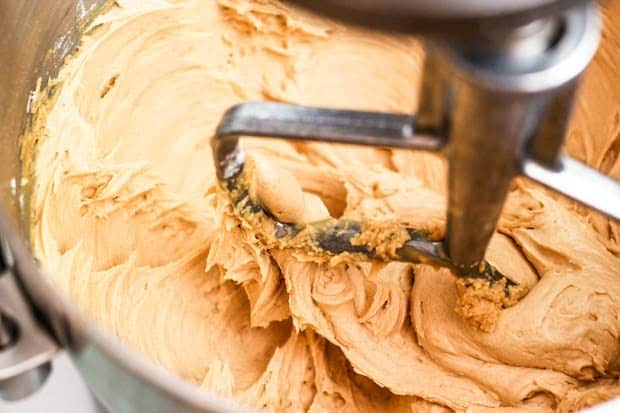 peanut butter frosting in a stand mixer bowl with the paddle attachment