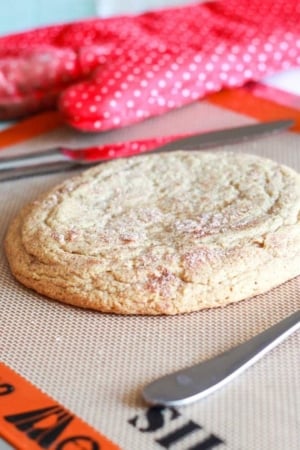 giant snickerdoodle cookie on a silpat baking mat