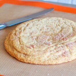 giant snickerdoodle cookie on a silpat baking mat