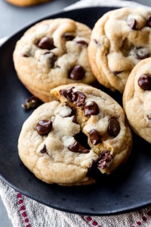 warm chocolate chip cookies on black plate