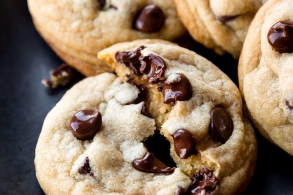 warm chocolate chip cookies on black plate