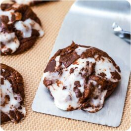York peppermint patty fudge cookies on a silpat baking mat with a metal spatula