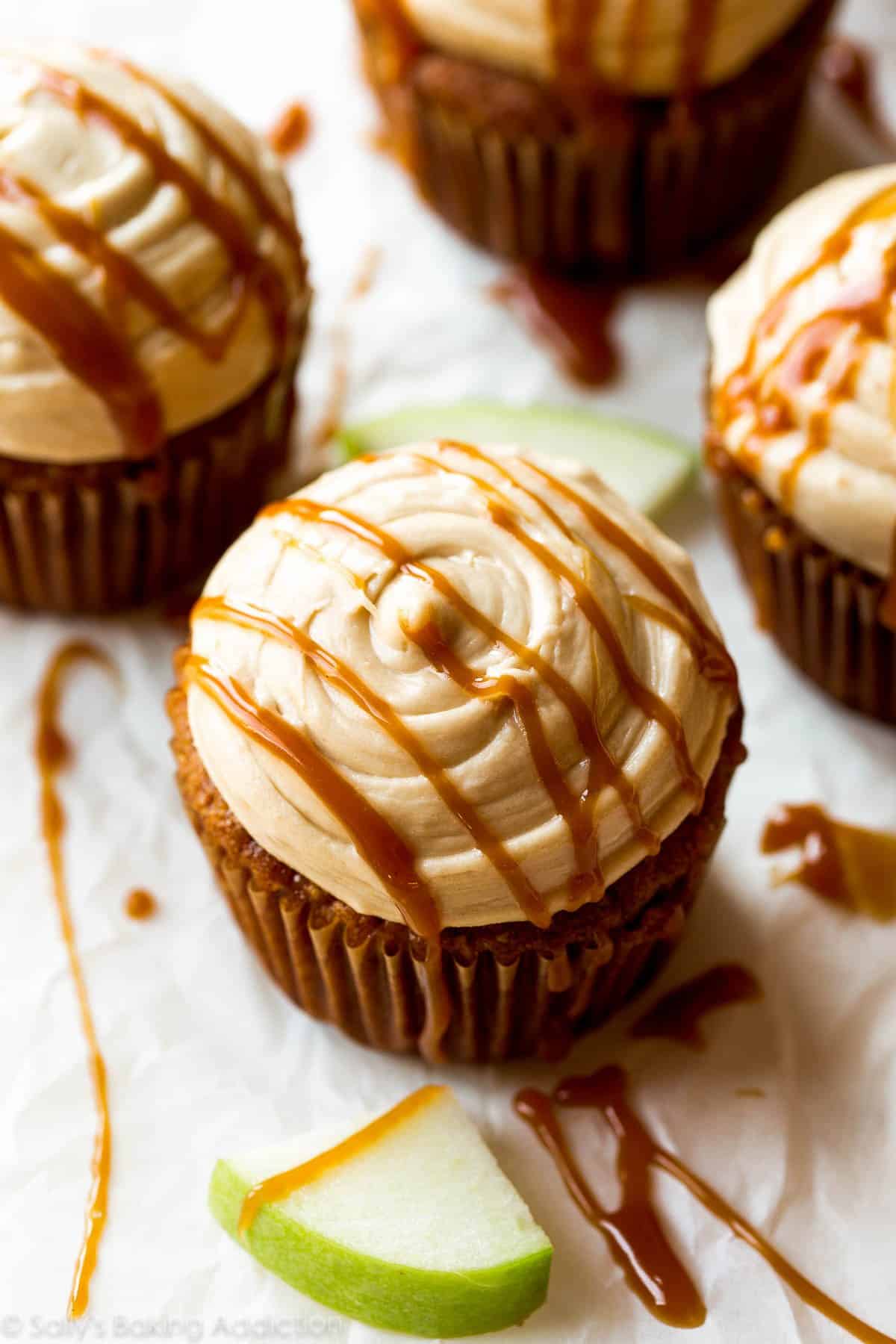 apple spice cupcakes topped with salted caramel frosting and a drizzle of salted caramel