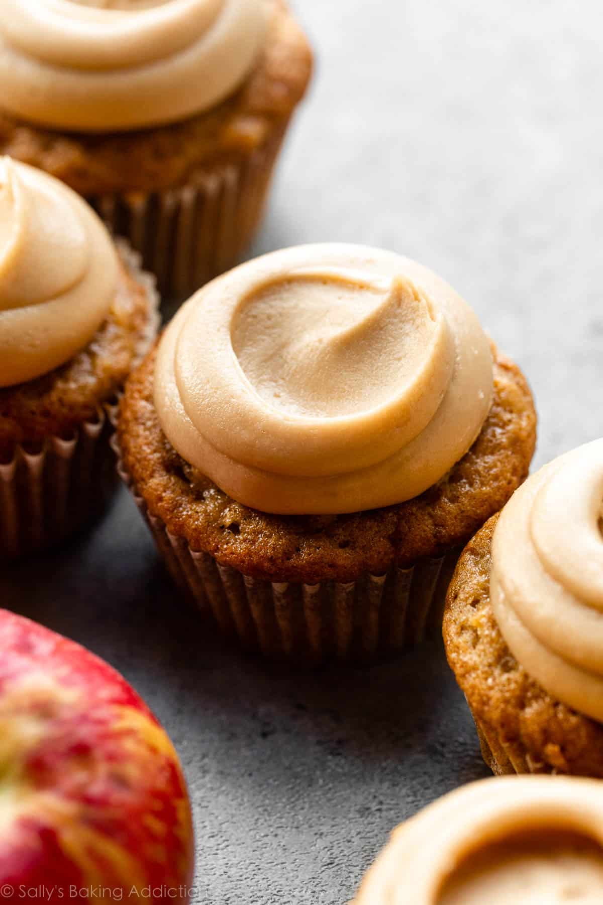 apple cupcakes with caramel frosting on top.