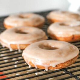 cinnamon bun donuts on a cooling rack