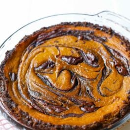 Nutella swirled pumpkin pie in a glass baking dish