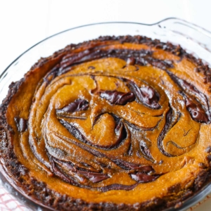 Nutella swirled pumpkin pie in a glass baking dish