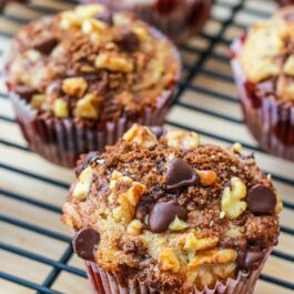 banana chocolate chip muffins with streusel topping on a cooling rack