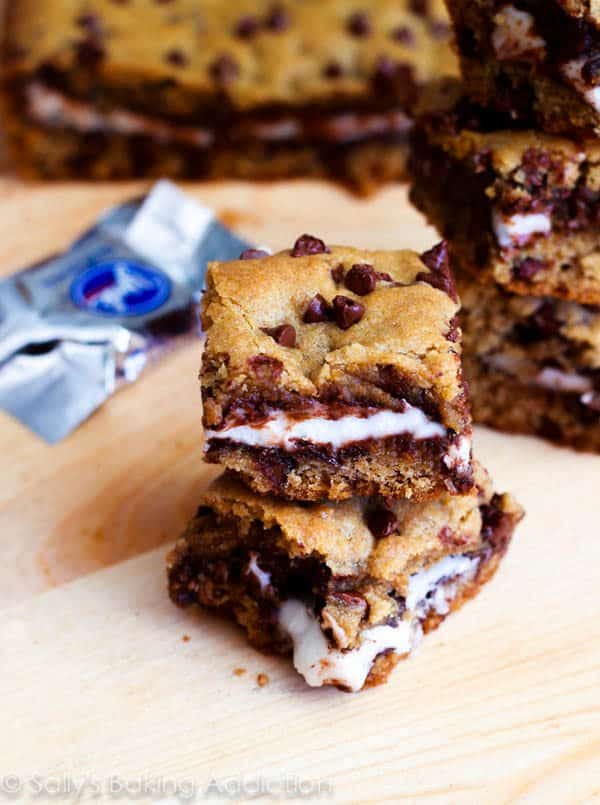stack of chocolate chip cookie bars stuffed with York Peppermint Patties on a wood board