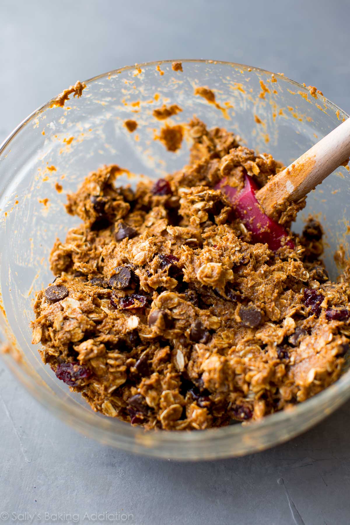 healthy pumpkin chocolate chip oatmeal cookie dough in a glass bowl with a spatula