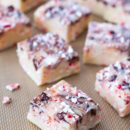 squares of candy cane chocolate swirl fudge on a silpat baking mat