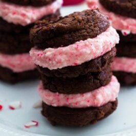 chocolate fudge sandwich cookies filled with candy cane buttercream on a white plate