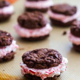 chocolate fudge cookies stuffed with candy cane buttercream on a silpat baking mat