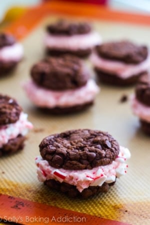chocolate fudge cookies stuffed with candy cane buttercream on a silpat baking mat