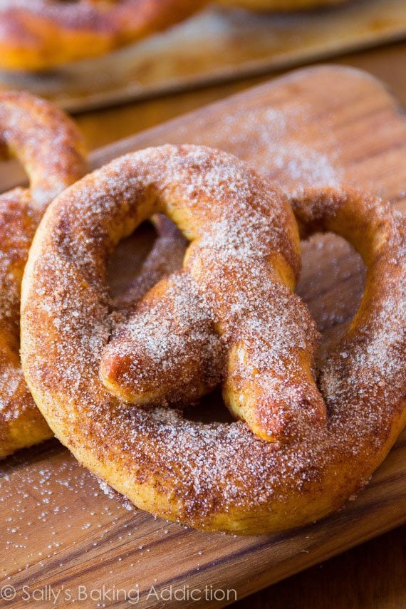 soft pretzels with cinnamon sugar topping on a wood board
