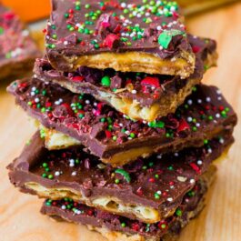 stack of pieces of chocolate peanut butter Saltine toffee with red and green sprinkles