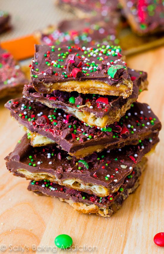 stack of pieces of chocolate peanut butter Saltine toffee with red and green sprinkles