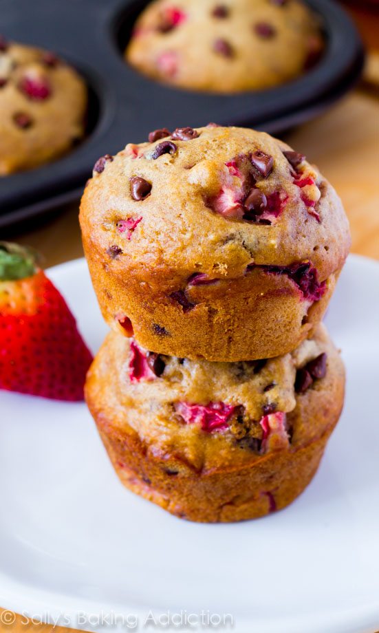 stack of 2 strawberry chocolate chip muffins on a white plate