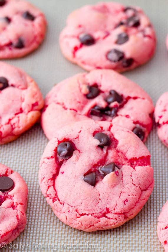 strawberry cookies with chocolate chips on a silpat baking mat