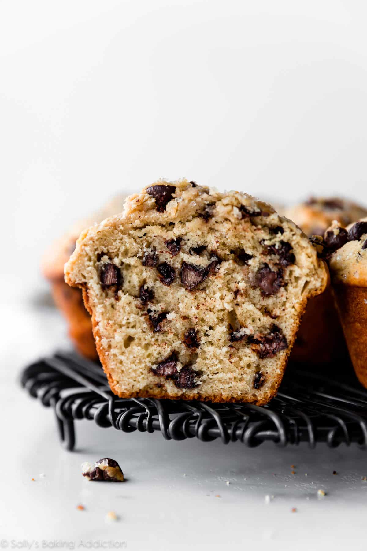 Bakery style chocolate chip muffin cut in half showing chocolate chips
