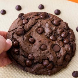 one giant chocolate cookie on a silpat baking mat