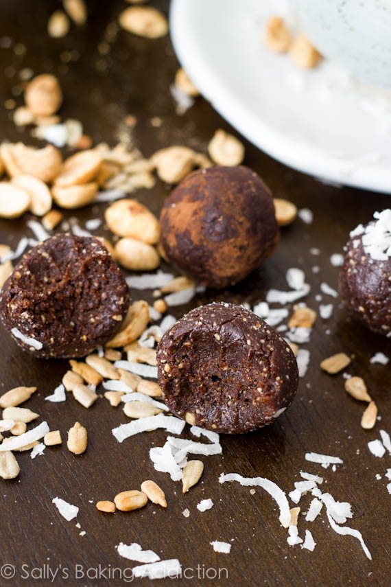 chocolate truffle energy bites with a bite taken from one showing the inside