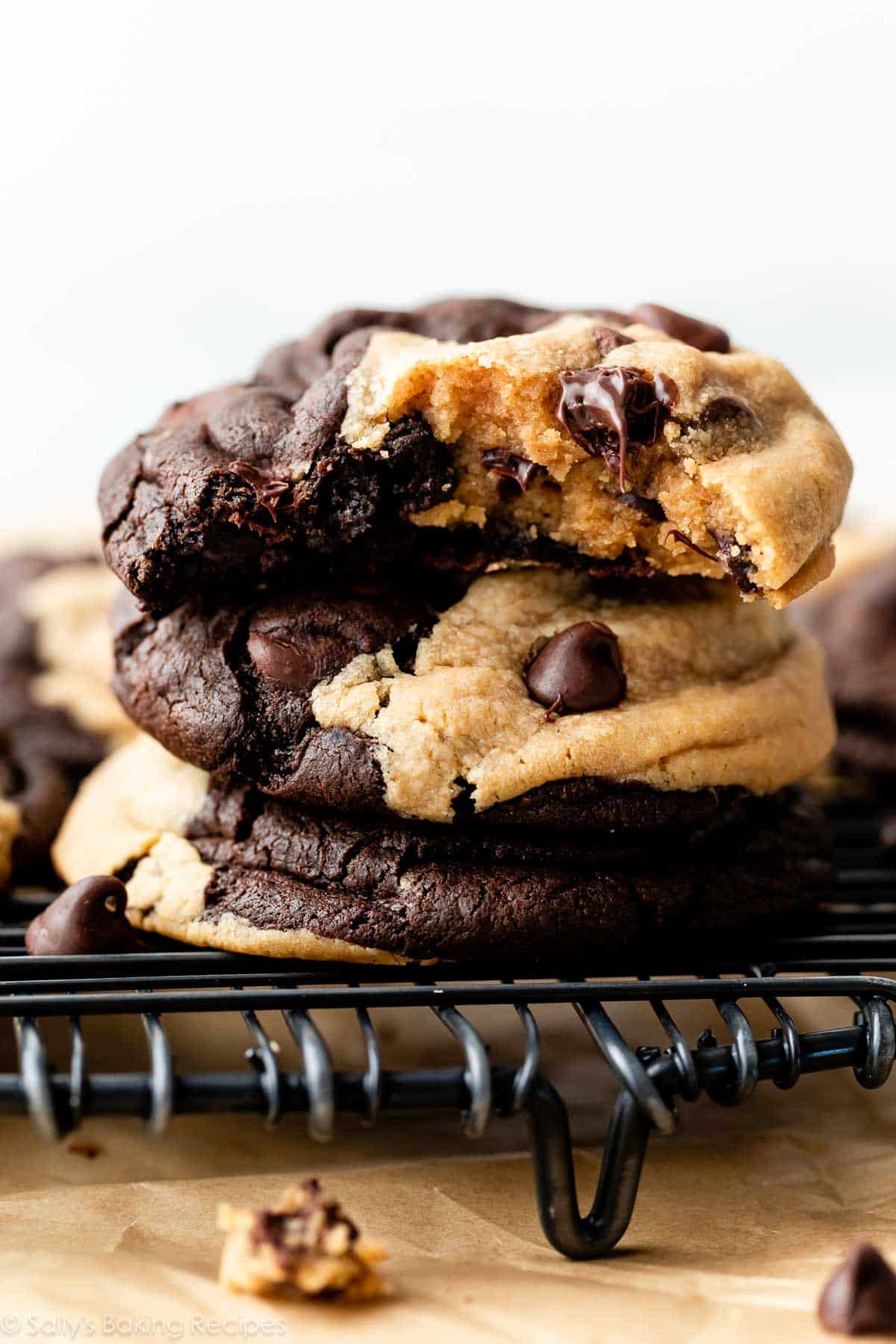 stack of peanut butter chocolate chip swirl cookies with top cookie with bite taken out.