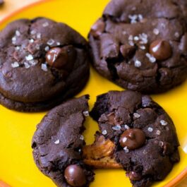 salted caramel dark chocolate cookies on a yellow plate