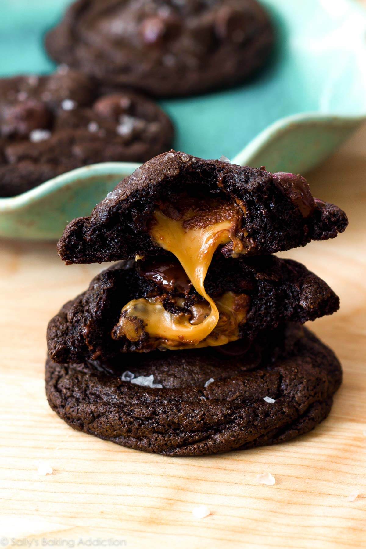 stack of salted caramel dark chocolate cookies with caramel in the middle