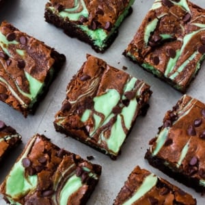 overhead image of mint chocolate chip cheesecake brownies on a baking sheet