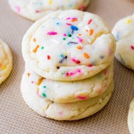 stack of funfetti sugar cookies on a silpat baking mat
