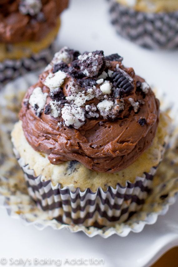 cookies and cream cupcakes topped with chocolate frosting and crushed Oreos