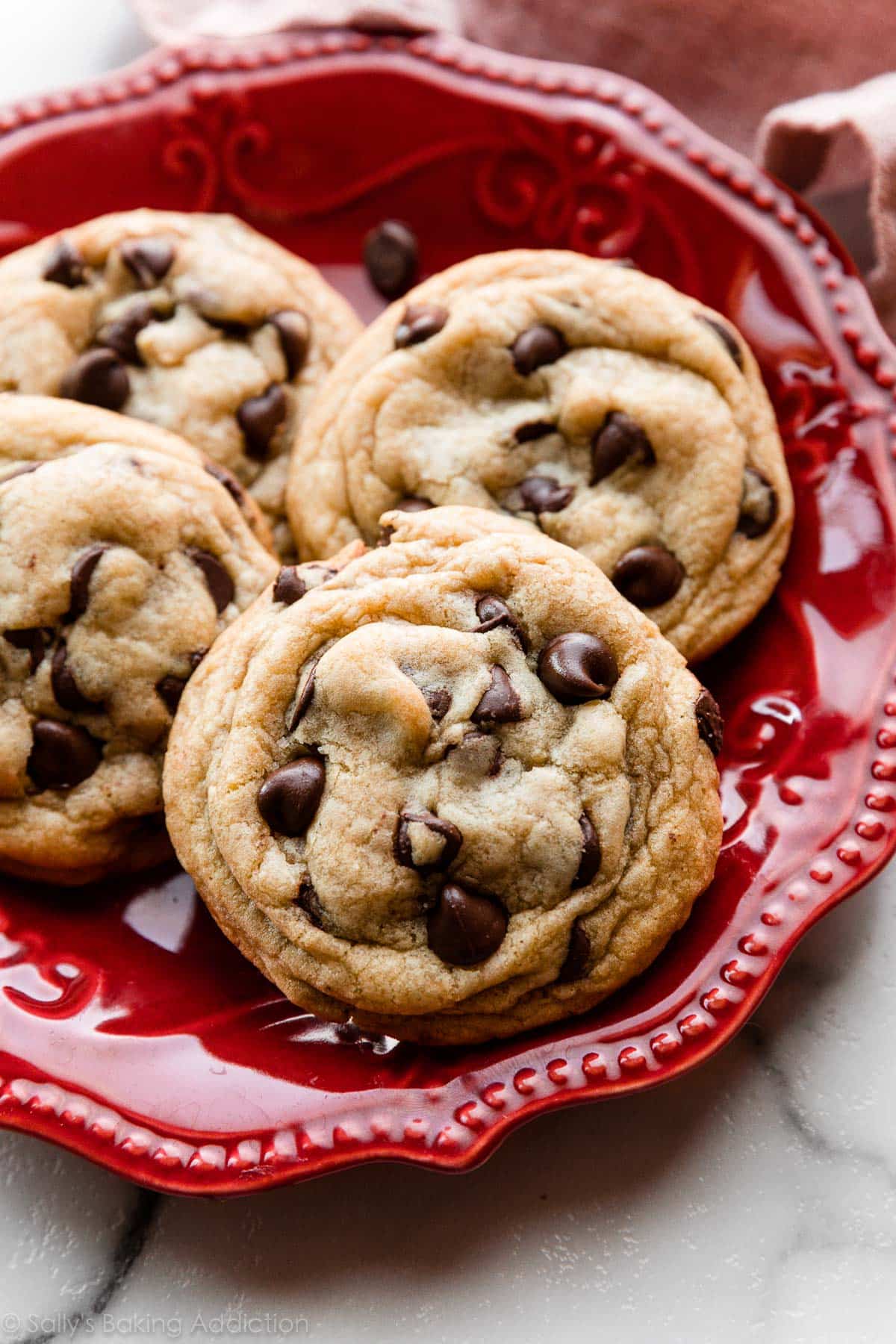 Chocolate chip cookies on a red plate