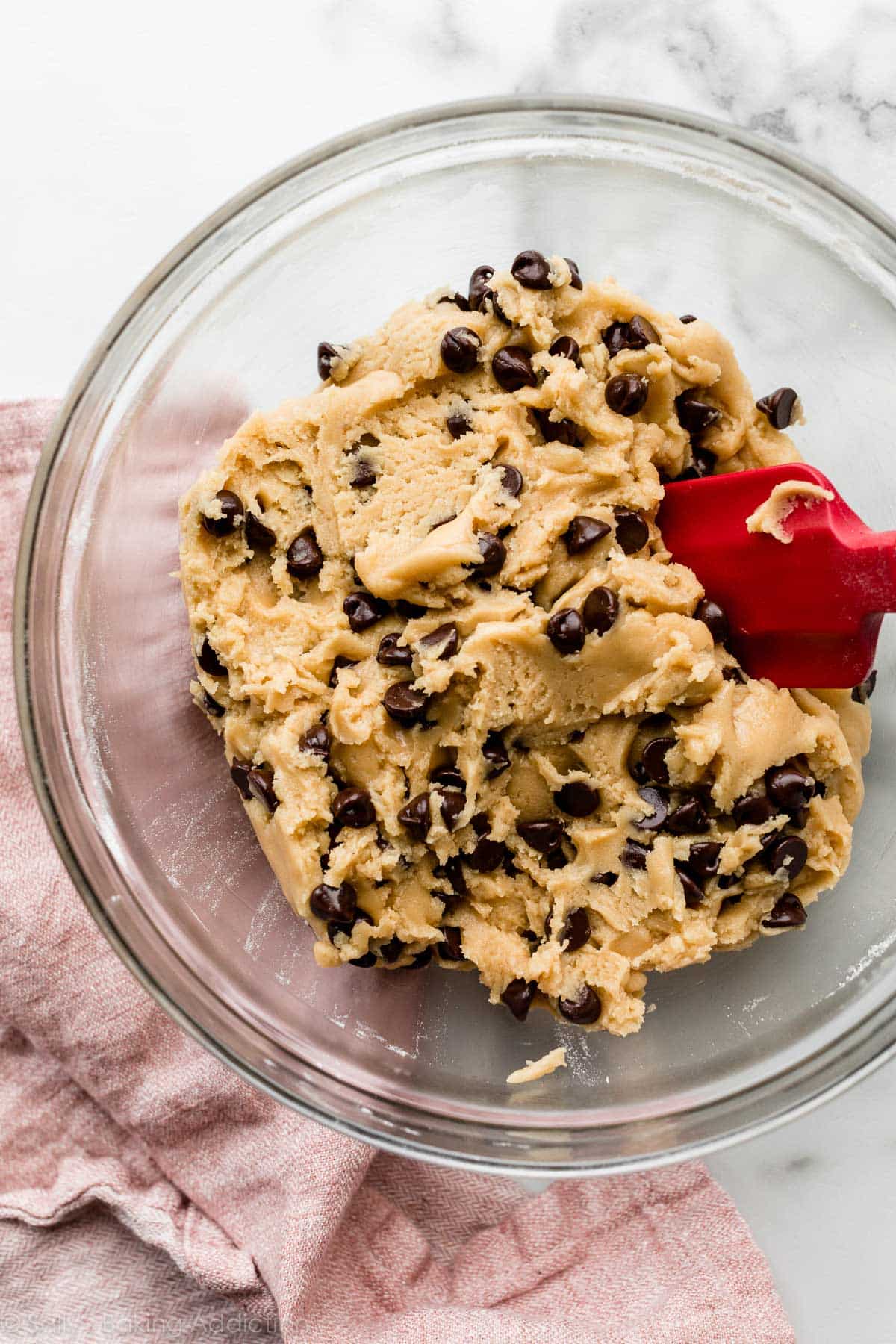 Chocolate chip cookie dough in a glass bowl